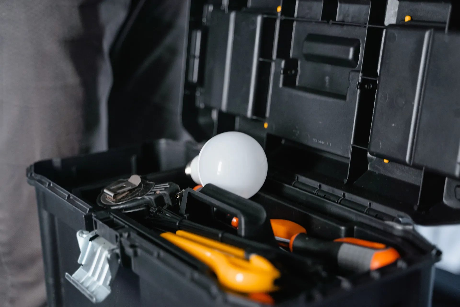 Open toolbox with hand tools and fittings for a maintenance visit
