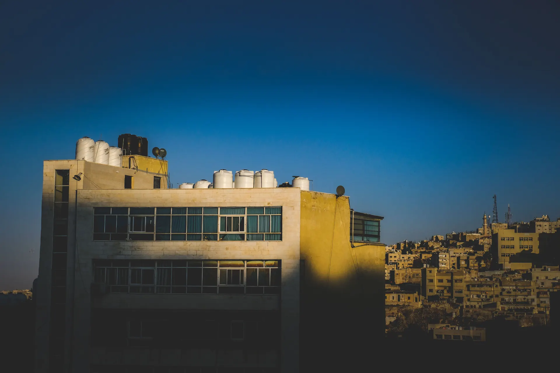Water storage tanks along the roof of a residential building