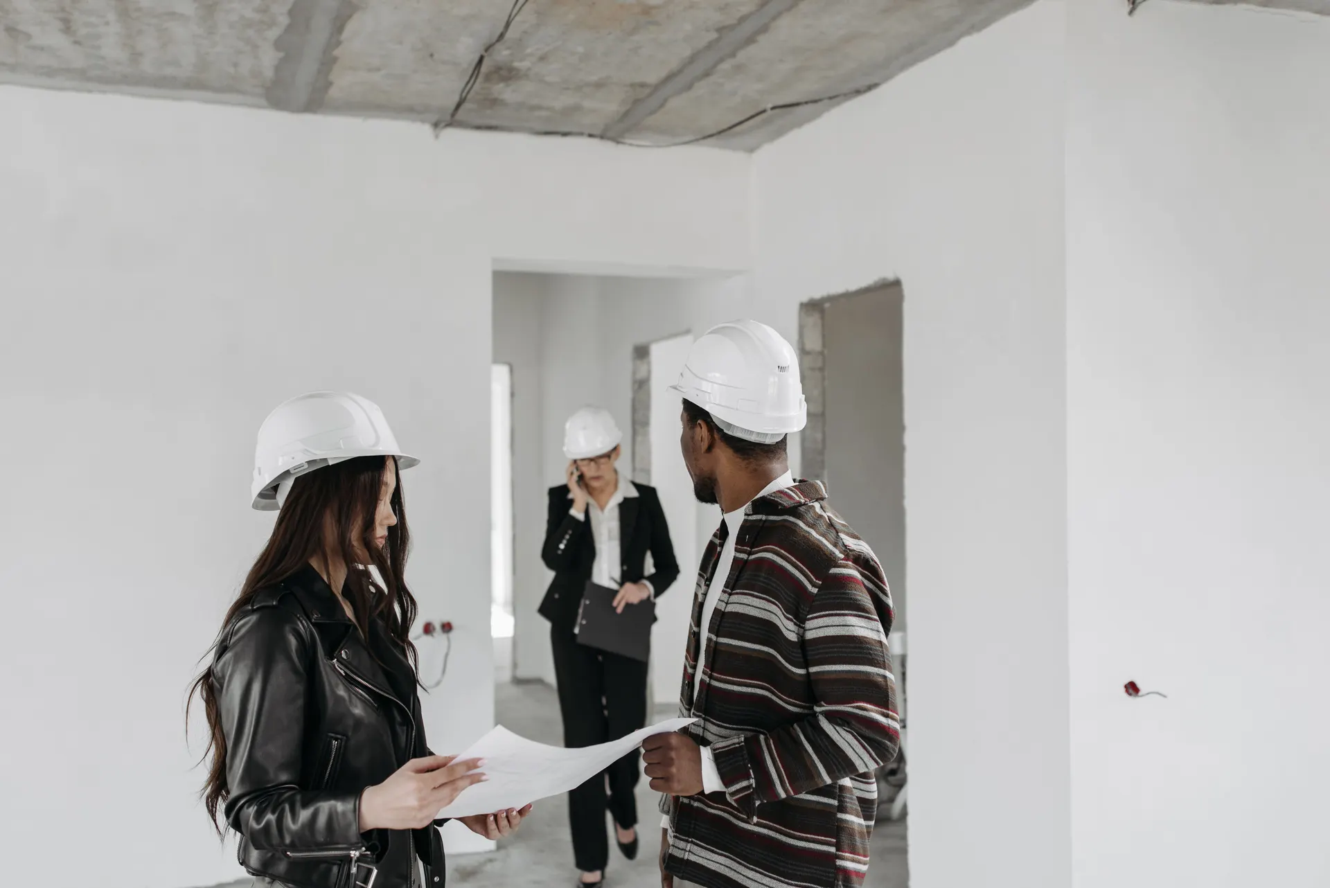 Site walkthrough with drawings inside a property being renovated