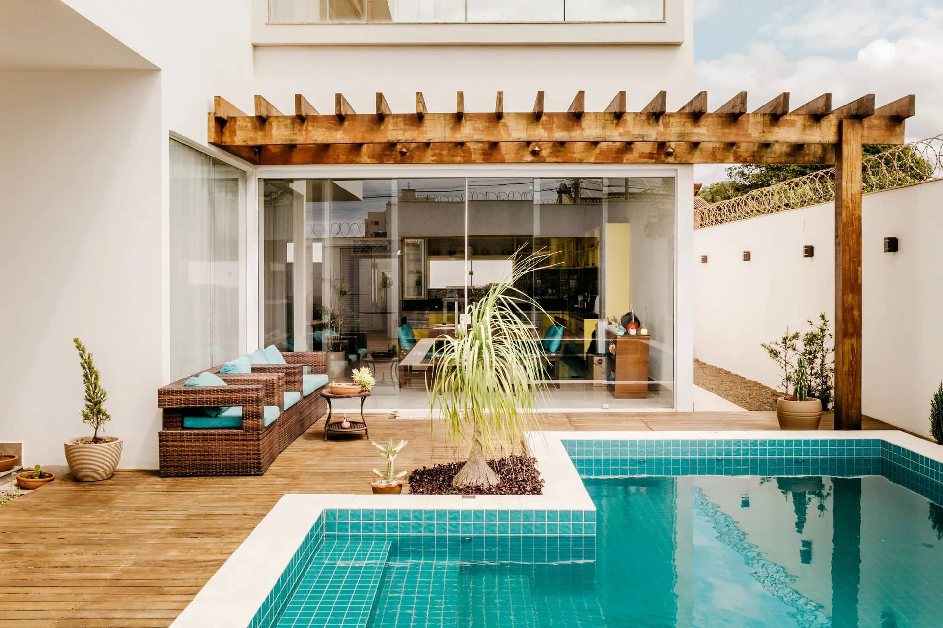 Villa terrace with a pergola, outdoor seating and a pool set into the deck